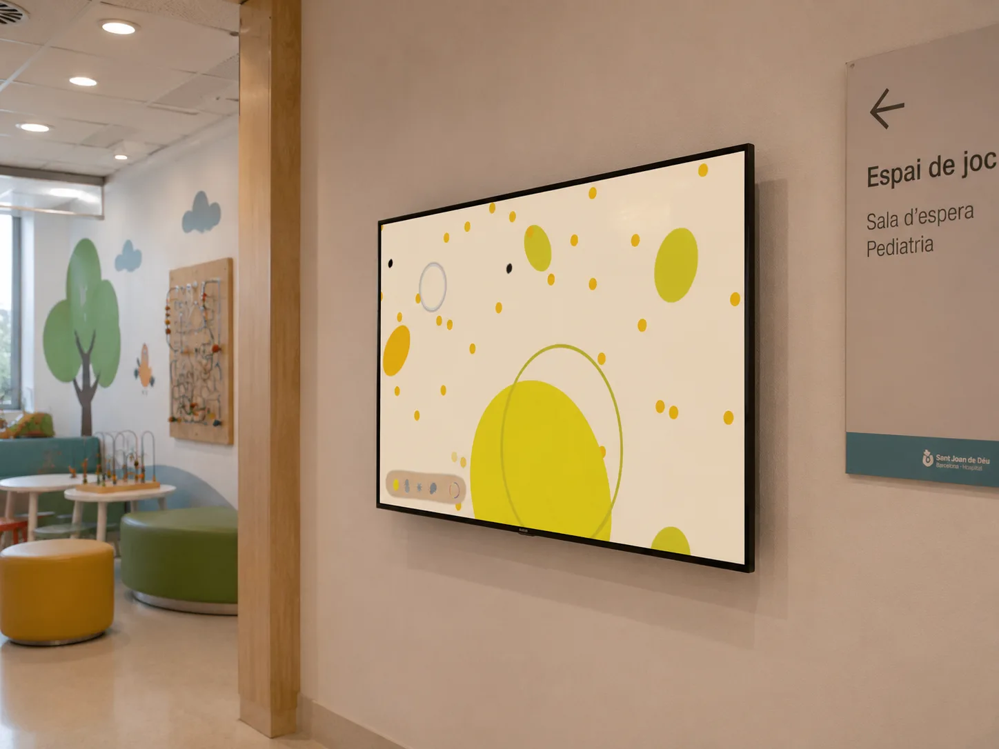 Hospital waiting room with yellow Aura emotion game displayed on wall-mounted TV screen