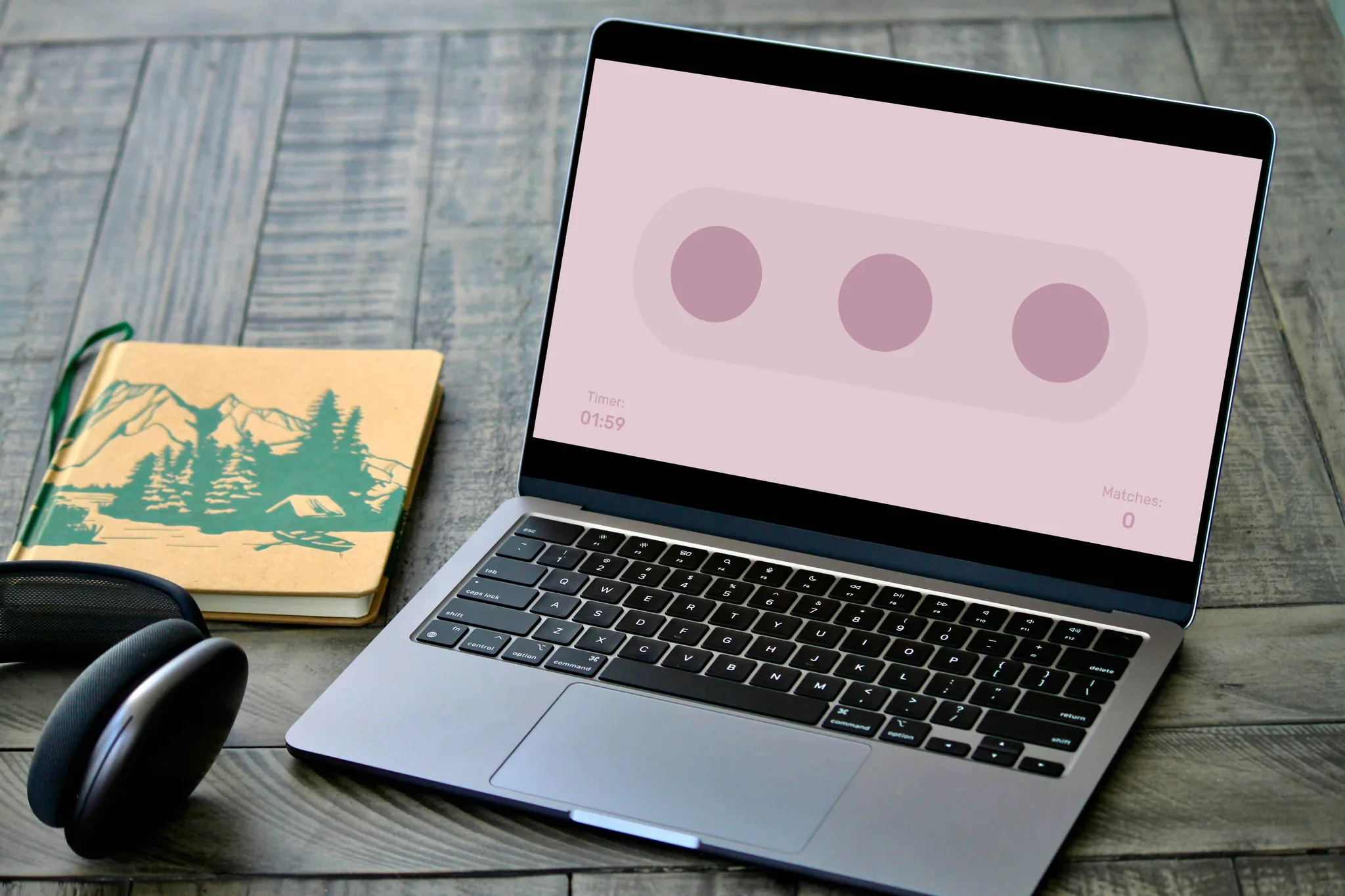 Laptop on a desk showing the pink dots matching mini-game