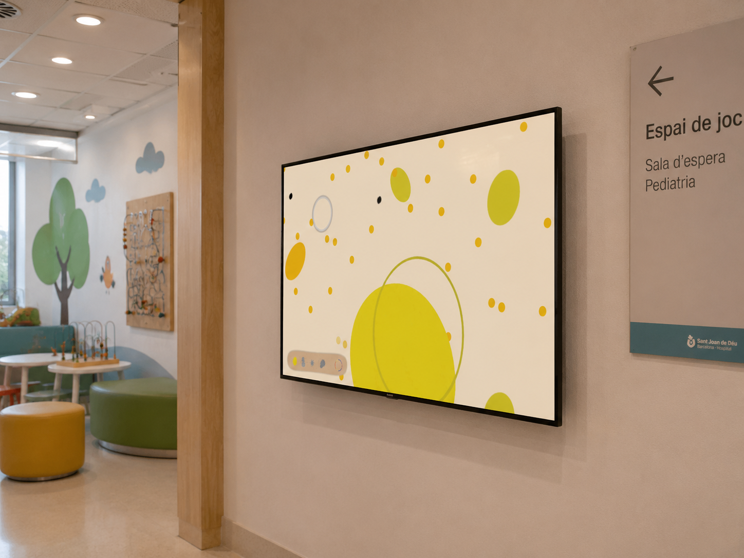 Hospital waiting room with yellow Aura emotion game displayed on wall-mounted TV screen