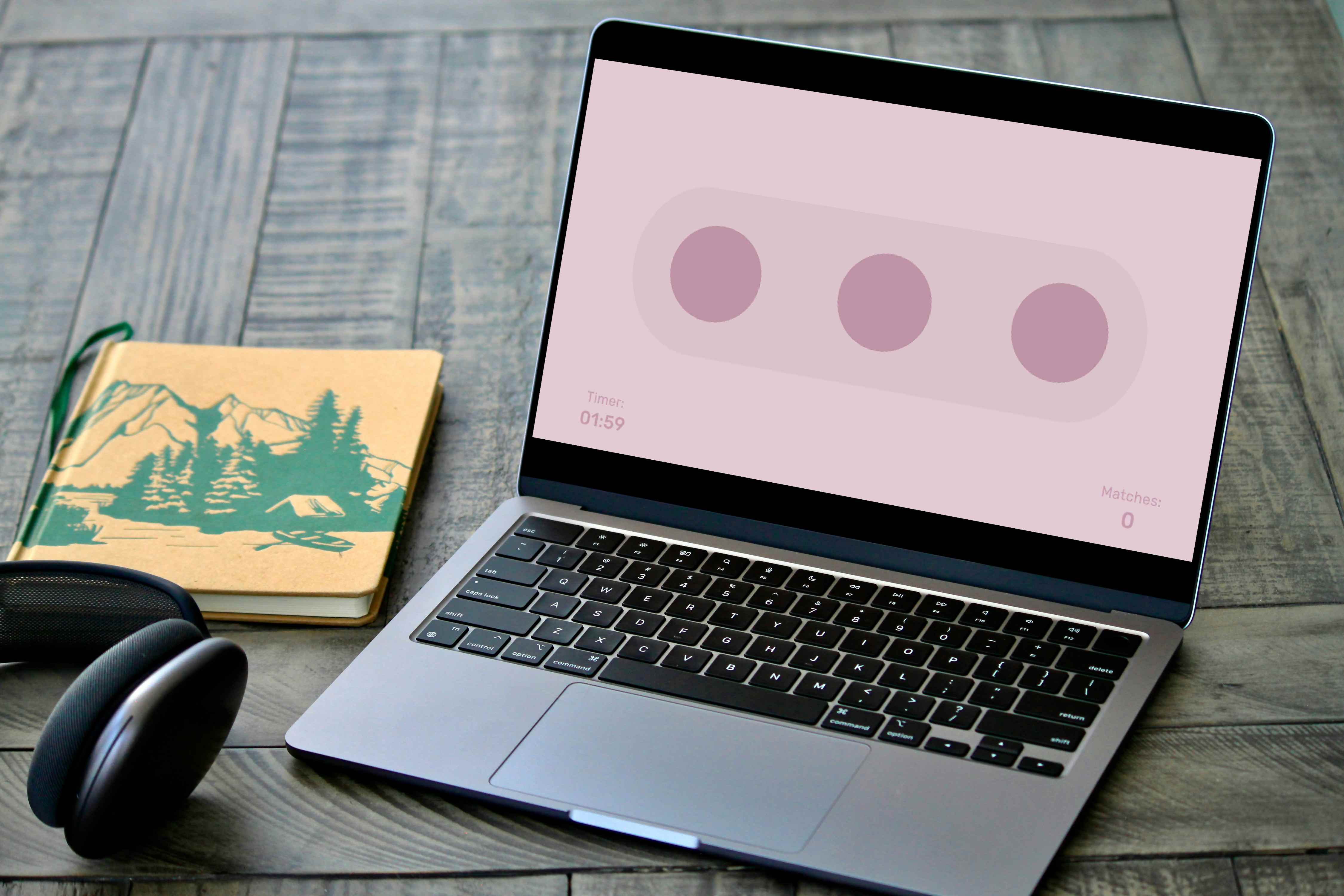 Laptop on a desk showing the pink dots matching mini-game