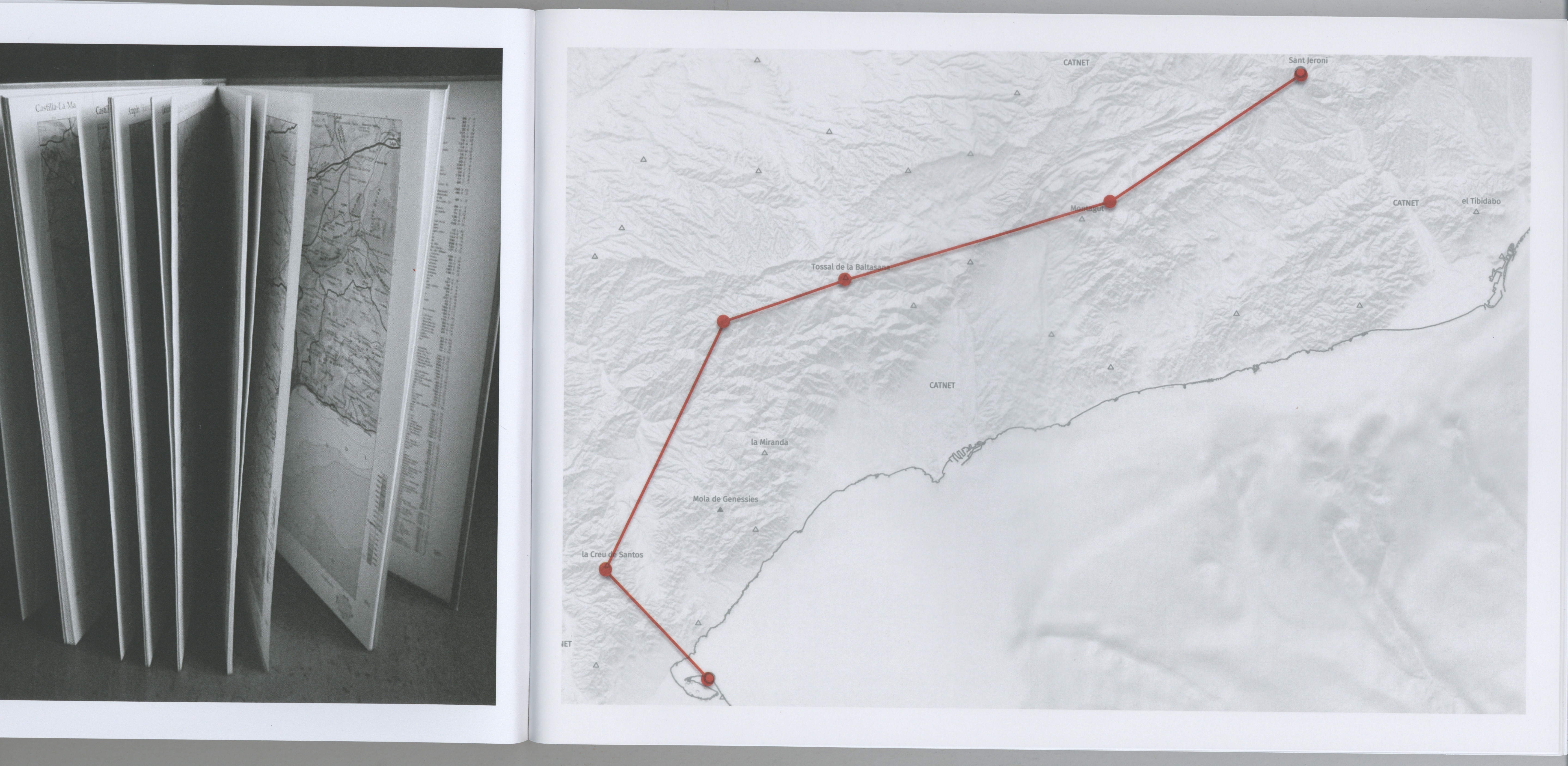 Book spread with folded map pages and a hand-drawn route on a topographic map of Catalonia