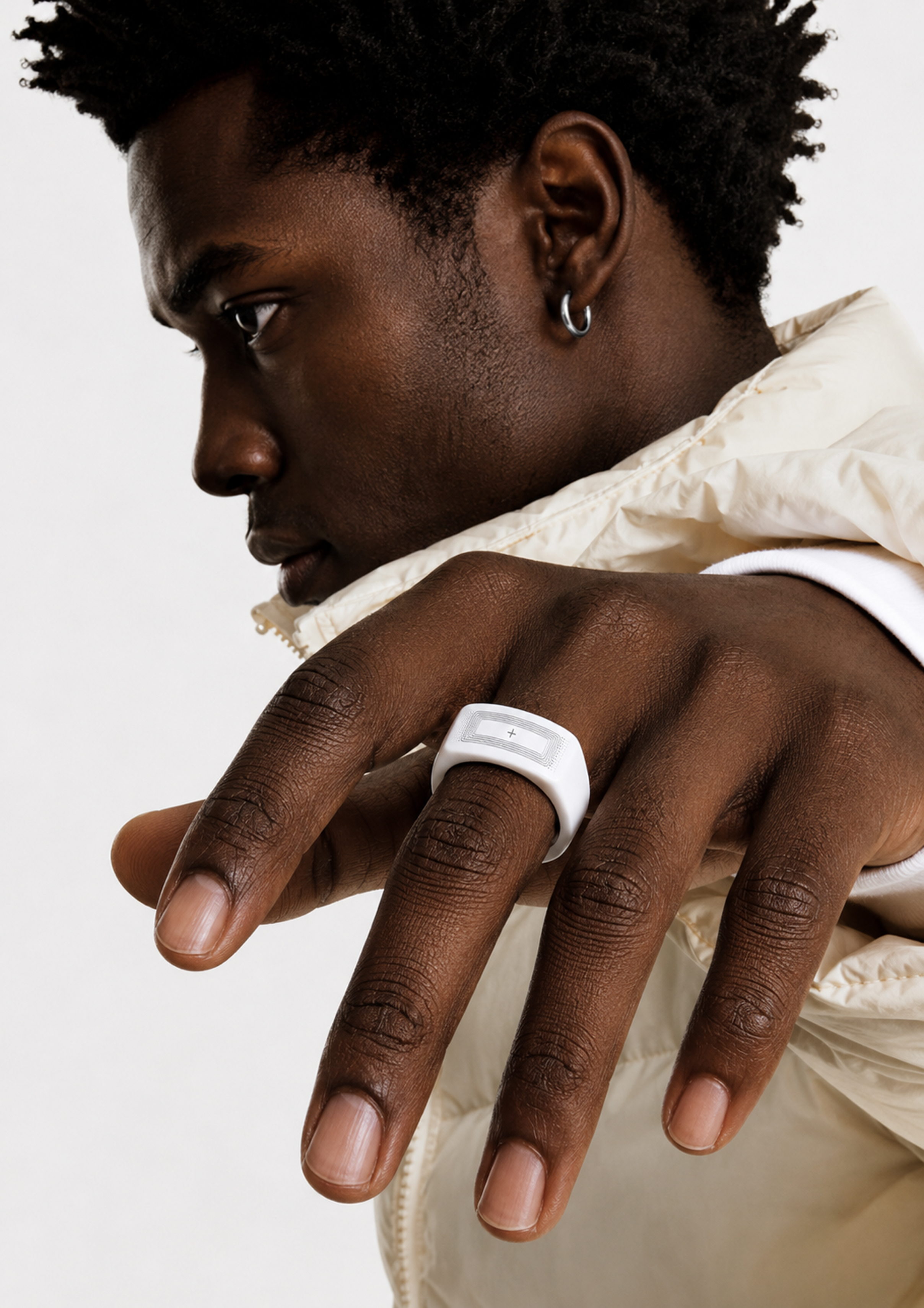 Man wearing a white ONNN ring, close-up portrait