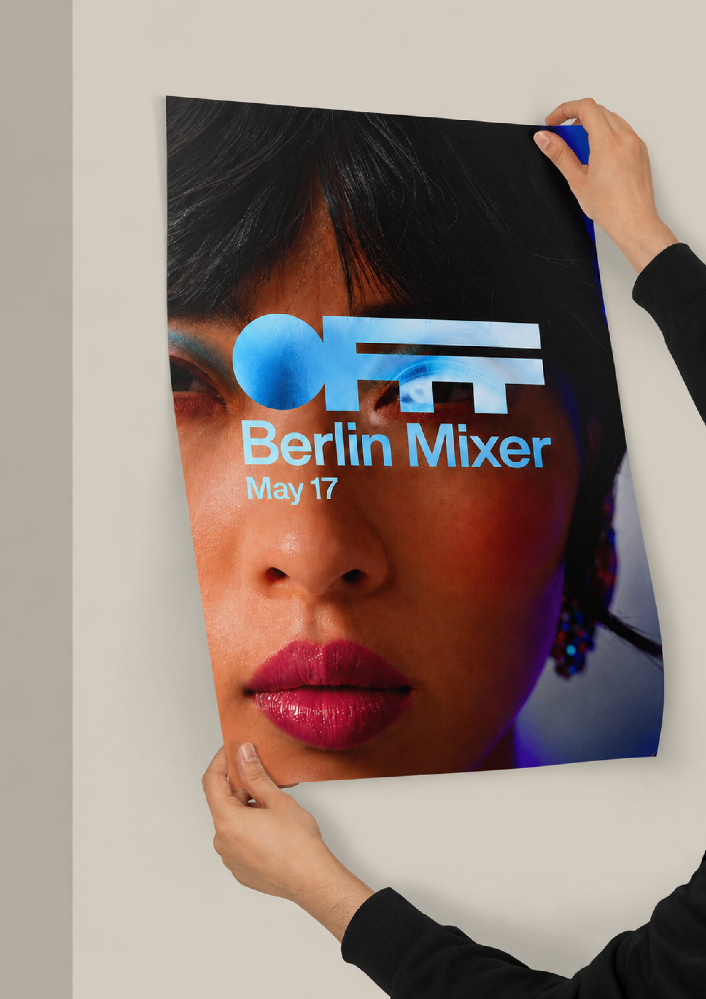 Hands holding an OFFF Berlin Mixer May 17 poster